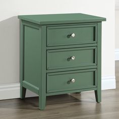 a green nightstand with three drawers on the bottom and one drawer in the middle, against a white wall