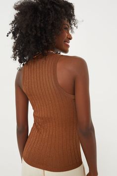 An upgrade to your classic tank, the Bronze Ari Tank is eye-catching in a metallic knit fabric. With a racerback design and form fit, this style is flattering and comfortable, making it perfect for day-long wear on its own or under a blazer. The neutral coloring creates a canvas for fun accessories, style it with a scarf and a crossbody for a chic day-time look or wear statement gold jewelry and a clutch for a polished yet elegant evening 'fit. Round neckline Sleeveless Racerback design Form fit Metallic Fitted Tank Top, Metallic Stretch Casual Tops, Casual Fitted Shimmer Tops, Casual Shimmer Tops, Casual Metallic Sleeveless Top, Metallic Knit, Olympia Le Tan, Fun Accessories, Accessories Style