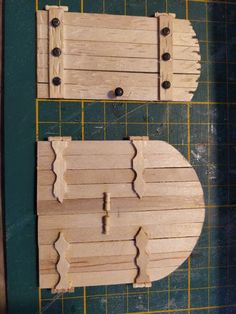 two pieces of wood cut out to look like doors