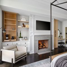 a bedroom with a fireplace and television in it