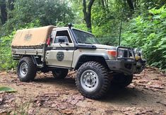 an off - road vehicle is parked in the woods