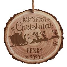 a baby's first christmas ornament hanging on a rope