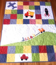 a quilt with cars and trucks on it