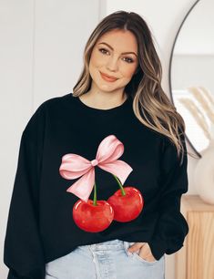 Introducing our Pink Bow Cherries Coquette Sweatshirt, a stylish and charming addition to your wardrobe! This unique sweatshirt features an adorable cherry bow motif, elegantly crafted with a ribbon-like design. Made with love and attention to detail, this cherry-inspired sweatshirt is perfect for those who love a touch of sweetness in their fashion statement. The soft and cozy fabric ensures comfort, making it an ideal choice for casual outings or lounging at home. Embrace the playful spirit of cherries, a delightful addition to any fashionista's collection! Coquette Sweatshirt, Coquette Clothing, Coquette Shirt, Unique Sweatshirt, Bow Shirt, Bow Shirts, Cozy Fabric, Hello Kitty Items, Dream Clothes