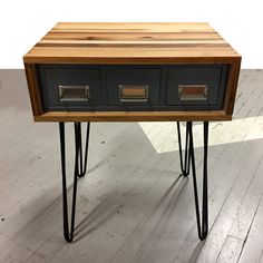 a wooden table with two drawers and hairpin legs