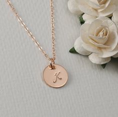 "The tiny 1/2\" pendant is a beautiful Rose Gold Filled round disc with your choice of name or initial. This disc is made from thick 20ga RGF. This is displayed perfectly on a 16\", 18\", or 20\" Rose Gold filled flat cable chain. AVAILABLE FINISHES: Smooth, Brushed, hammered edges, hammered disc Please send me a convo (click on \"contact\") if you are not sure if your personalization will fit. Some of the designs are too large to fit on the disc with letters. Please provide the following inform Rose Gold Hand Stamped Round Charm Necklaces, Rose Gold Hand Stamped Charm Necklaces With Round Shape, Rose Gold Initial Necklace For Personalized Gift, Rose Gold Hand Stamped Charm Necklace, Dainty Rose Gold Round Pendant Name Necklace, Rose Gold Initial Necklace With Round Pendant, Rose Gold Initial Necklace As Personalized Gift, Rose Gold Round Initial Necklaces, Rose Gold Charm Necklace With Initials