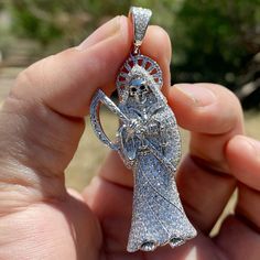 Large Santa Muerte (Grim Reaper) pendant. Solid 925 sterling silver w/rhodium finish. Will fit most chains up to 6 mm thick. 2" tall (with bale its 2.5" inch) x .75" wide. The pendant bale is stamped with "925". Real precious metal - won't ever turn green. Has a caged back for strong support. Nice solid weight to it at 17 total grams. 200 hand set micro paved (cz)- total of 3 ct. This piece shines so bright it will blind you. 100% FREE SHPPING in USA. Order now! Bride Of Chucky, Pave Pendant, Jewelry Fashion Trends, Mens Pendant, Hip Hop Jewelry, Fabulous Jewelry, Grim Reaper, Dream Jewelry, Micro Pave