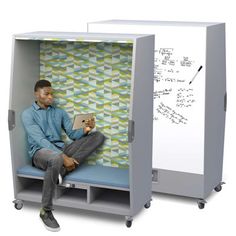 a man sitting on a bench in front of a whiteboard