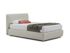 a bed with a white headboard and brown pillows on it's sides, in front of a white background