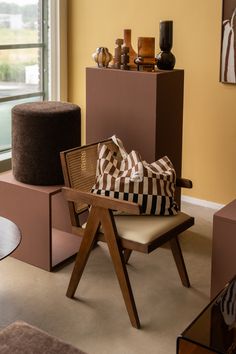 a chair with a checkered bag sitting on top of it next to a window