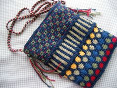 two crocheted bags sitting on top of a white tablecloth covered bed next to each other