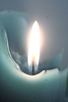 a candle is lit in the dark with water on it