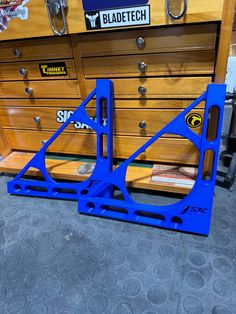 there are two pieces of blue plastic on the floor next to each other in front of a dresser