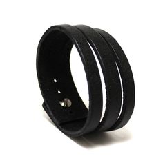 Minimalist narrow and chick men leather cuff of genuine leather (approx 3 mm thickness) in deep black color with soft gloss effect. One screw leather stud used as clasp. Not very wide but looks as many bracelets on a wrist. Our other bracelets here https://etsy.com/shop/PrideAndBright ★ SPECIFICATIONS ★ * Handmade product * Natural Tanned Leather * Color: black color * Size: Best suited for wrist size from 6.7in/16cm till 7.5in/19cm * Screw button stud Modern Adjustable Leather Bracelet With Waxed Finish, Modern Black Leather Strap Wristband, Classic Black Leather Bracelet For Business, Minimalist Adjustable Leather Wristband, Classic Adjustable Leather Bracelet For Business, Adjustable Minimalist Leather Wristband, Modern Adjustable Leather Wristband, Classic Leather Bracelet With Black Band, Classic Black Bracelets With Wrist Strap