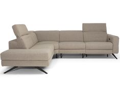 a large sectional couch sitting next to a footstool on top of a white floor