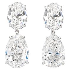 These luxurious GIA certified dangle earrings showcase a harmonious blend of pear and oval cut diamonds set in 18K white gold. The pear-shaped diamonds, weighing 3.01 and 3.05 carats respectively, take center stage, while the smaller oval-cut diamonds are elegantly positioned above them, adding graceful balance. With an F color grade, these diamonds exhibit a near-colorless brilliance, while their internally flawless clarity ensures a pristine appearance. The cut and polish of all diamonds are graded excellent, maximizing their sparkle. One diamond boasts excellent symmetry, while the other has a very good rating. With no fluorescence in one diamond and faint in the other, these earrings are a true testament to timeless elegance and craftsmanship. Luxury Gia Certified White Earrings, Luxury Pear-shaped Fine Jewelry Earrings, Lux Jewelry, White Diamond Jewelry, Luxe Jewelry, Diamond Dangle Earrings, Precious Jewels, Expensive Jewelry, Jewelry Lookbook