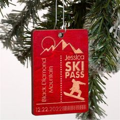 a red ski pass ornament hanging from a christmas tree