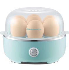 three eggs in an egg cooker on a white background