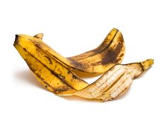 two ripe bananas sitting next to each other on a white surface