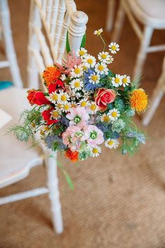 a bouquet of flowers sitting on top of a white chair