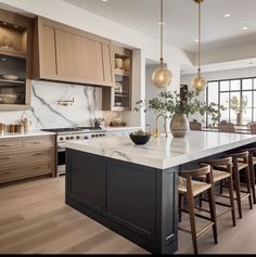 a kitchen with marble counter tops and wooden stools next to an island in the middle