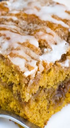 a piece of cinnamon roll cake on a plate with a fork and knife next to it