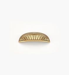 a gold plated metal object on a white background