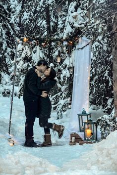 a man and woman kissing in the snow