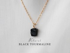 This is a raw black tourmaline necklace. The black gemstone is one of the most sought-after healing stones for protection and purification. It is a handmade necklace and perfect as a gift for you or your beloved ones! Birthstone necklace October. Availabe as a black tourmaline pendant or necklace.  >>100% HANDMADE IN GERMANY ✺ MATERIAL ✺ Pendant only (Only Pendant):  Wire material  -Gold-filled -Sterling silver 925  With chain (With Chain): - Delicate gold (genuine 24 K gold-plated) - Delicate silver (Sterling silver 925) Natural black tourmaline Size: 8-10mm  PLEASE take into account the natural variations of the crystals. As this is a natural product, size and color may vary. Every stone is unique, just like you! Each piece will therefore differ from the picture.  ✺ LENGTH ✺ Length of th Stones For Protection, Black Tourmaline Necklace, Raw Black Tourmaline, Raw Tourmaline, Necklace Birthstone, Tourmaline Pendant, Tourmaline Necklace, Protection Stones, Necklace Black