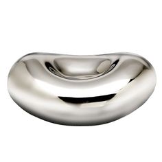 a metal object that is shaped like a wave on the side of a white wall