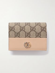 Gucci's wallet is made from durable textured-leather with a signature coated-canvas outer, so it will easily withstand constant use and survive knocks and scrapes in the bottom of your bag. Topped with a tonal logo plaque, it's fitted with five card slots and a zipped compartment to secure coins. Gucci Brown Wallets With Interior Card Slots, Brown Gucci Wallets With Interior Card Slots, Classic Gucci Wallet For Travel, Classic Gucci Travel Wallet, Gucci Bifold Wallet For Everyday Use, Luxury Beige Wallet For Daily Use, Designer Beige Wallets With Interior Card Slots, Designer Beige Wallet With Interior Card Slots, Designer Beige Wallet With Card Slots