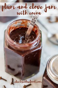 an image of plum and clove jam with cocoa in a glass jar on the table