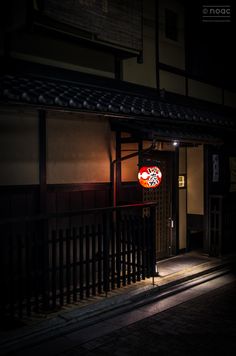 a building with a sign on the door at night