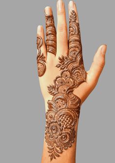 a hand with henna tattoos on it