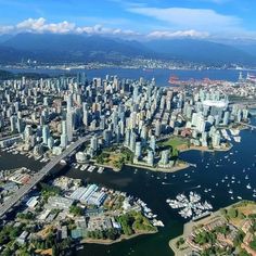 an aerial view of a city with boats in the water