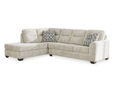 a sectional couch with pillows on the back and side facings, sitting against a white background