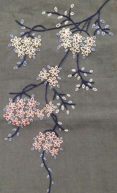 an embroidered piece of cloth with flowers on it