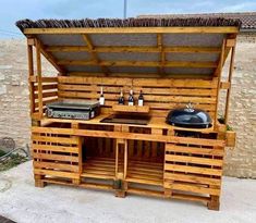 an outdoor kitchen made out of pallet wood