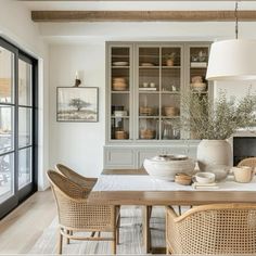 the dining room table is set with wicker chairs