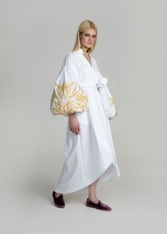 Luxurious White/Gold Kolossya Women's Midi Caftan Yuliya Magdych Spring Cotton Kaftan With Floral Embroidery, Elegant Cotton Kaftan For The Beach, Elegant Cotton Beach Kaftan, Elegant Summer Cotton Kaftan, Elegant Spring Kaftan With Intricate Embroidery, Elegant Spring Kaftan With Embroidered Sleeves, Elegant Cotton Dress With Geometric Embroidery, Spring Embroidered Dress With Woven Motifs, Elegant Cotton Kimono