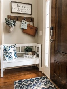 a white bench sitting next to a wooden door