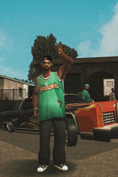 a man is standing in front of a car and waving at the camera while wearing a green shirt