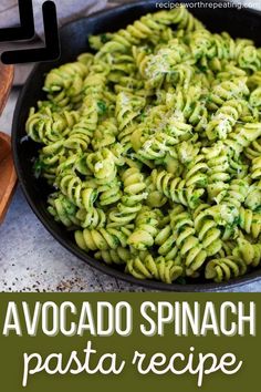 a pan filled with pesto spinach pasta on top of a table