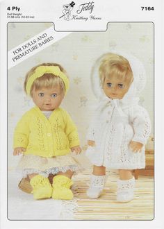 two dolls sitting next to each other wearing knitted clothes and bonnets on the floor