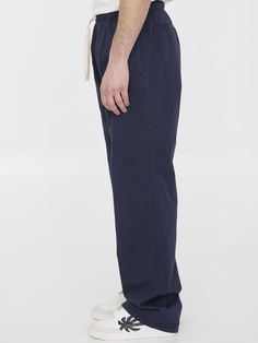 Navy blue cotton pants with embroidered Palm Angels logo on left leg. It features stretch waistband with drawstring, two side welt pockets and two rear buttoned welt pockets. Relaxed fit. The model is 190cm tall and wears size IT 48. Size nationality: IT Product number: 1858676 Product code: PMCA141S24FAB0014603 Composition: 100% cotton Logo Pants, Angels Logo, Platform Wedge Heels, Palm Angels, Dress With Cardigan, Cotton Pants, Clothes Collection, Bag Straps, Welt Pockets