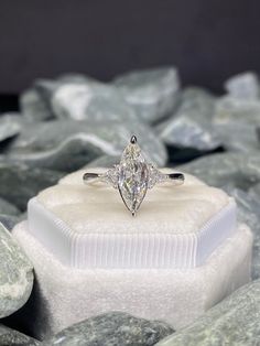 a diamond ring sitting on top of a white box