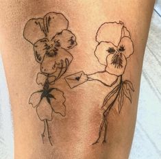 a woman's thigh with two flowers on it