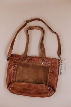 This is the leather bag you have dreamed about. The Bedstu Renata Bag in pecan is a favorite of ours at ECB. Such a rich and beautiful color that is perfect for the fall season. We can't wait to see how you style this gorgeous bag! Zipper ClosureRolled Leather HandlesHand Distressed Leather ExteriorInterior Zip Pocket12in.W x 12in.H x 3.5in.D12.5in. Handle Drop﻿Need help with sizing? No problem! Join our VIP group on Facebook, Everyday Chic Boutique VIP Insiders to chat directly with our team and other customers just like you Packaged with love and shipped from our warehouse in Wilmington, Ohio Dark Tan Leather Bag For On-the-go, Textured Leather Travel Bags For Fall, Fall Travel Bags In Textured Leather, Luxury Leather Handle Shoulder Bag For Fall, Fall Leather Lined Satchel Shoulder Bag, Luxury Brown Satchel For Fall, Vintage Brown Textured Leather Bag For Everyday Use, Brown Textured Leather Shoulder Bag For On-the-go, Fall Cognac Bag With Adjustable Strap