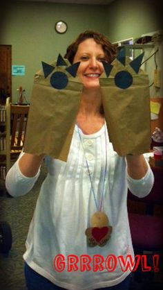 a woman holding up two bags that look like monster's heads and hands with the words grrowwol on them