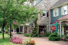 an outside view of a store with flowers in the foreground